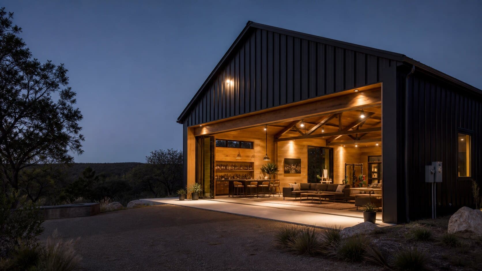 Modern black private barn with open indoor outdoor lounge in the Texas Hill Country